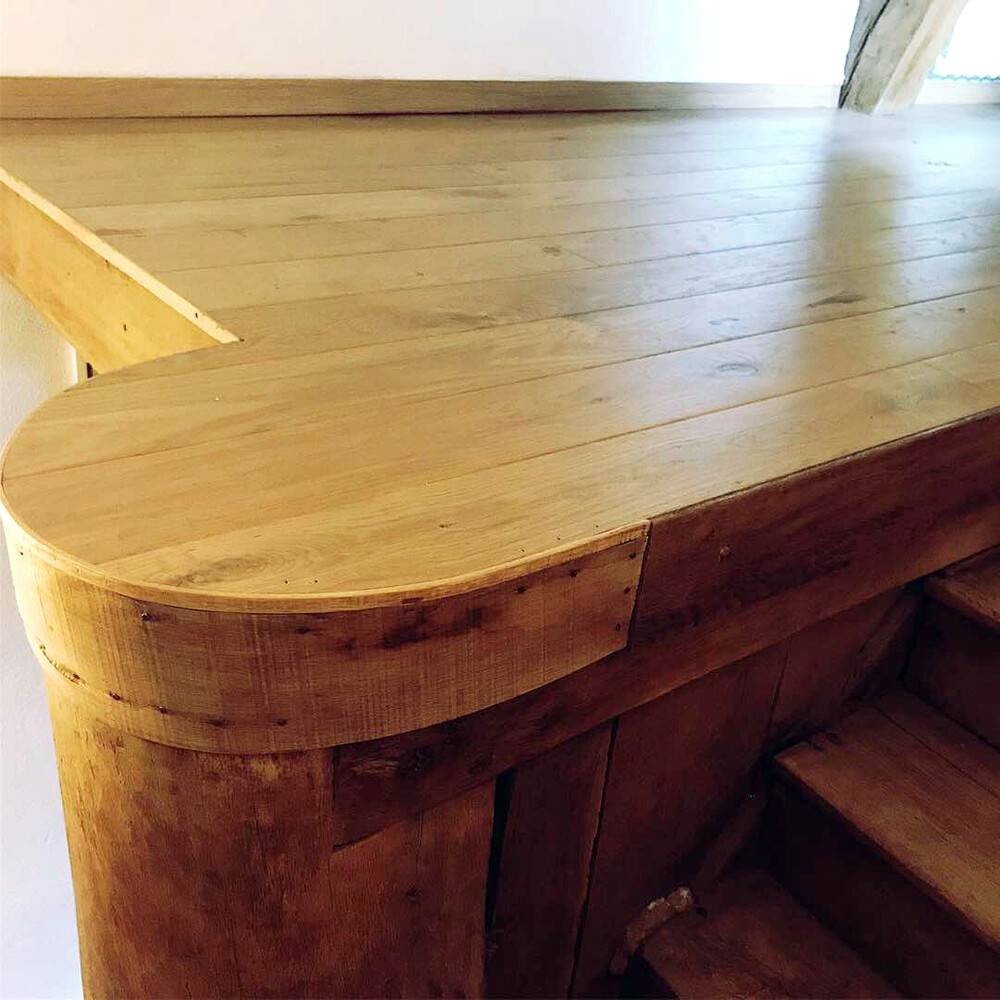 Comptoir de bar en bois massif aux formes courbes