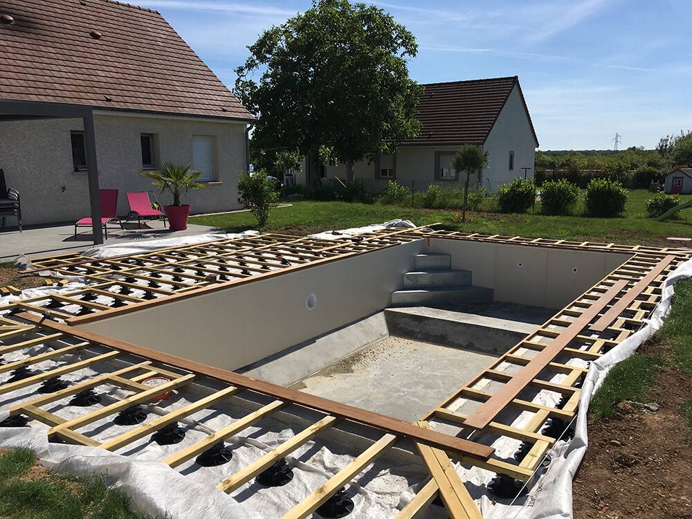 Structure de terrasse bois en cours autour d'une piscine